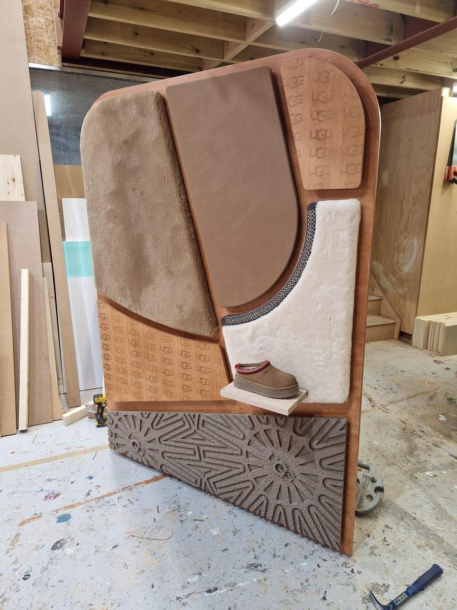 CNC routed UGG retail display unit with branded panels, machined by Rule One CNC London